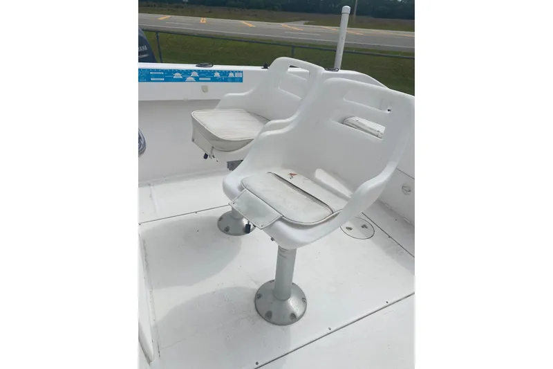 Slide: The Image of Two white seats on a 2001 Angler 2100 Center Console boat. - 6