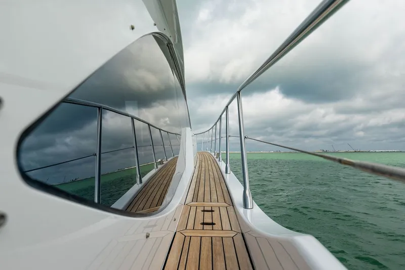 Slide: The Image of Azimut 55 from 2022 on calm water with wooden deck and stainless steel railing. - 14