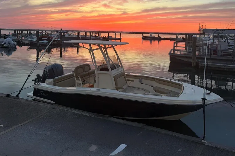 The Image of 2018 Scout 215 XSF boat docked at sunset with vibrant sky. - 1
