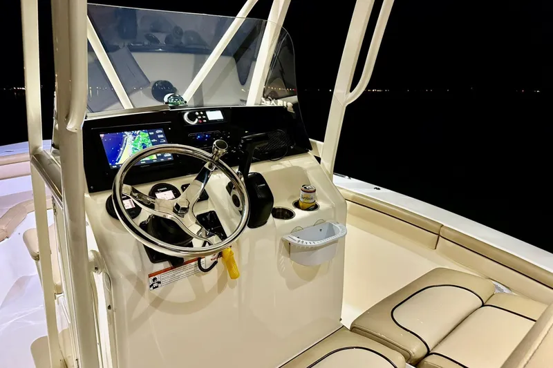 Slide: The Image of 2018 Scout 215 XSF boat cockpit with steering wheel and navigation system at night. - 10