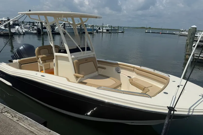 Slide: The Image of 2018 Scout 215 XSF boat docked at marina, featuring sleek design and spacious seating. - 3