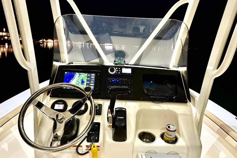 Slide: The Image of 2018 Scout 215 XSF boat dashboard with navigation system at night. - 5