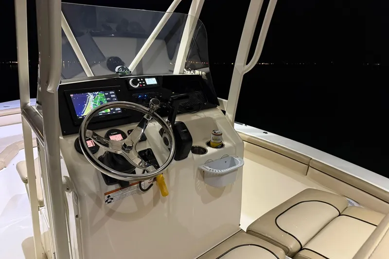 Slide: The Image of 2018 Scout 215 XSF boat cockpit at night with illuminated controls and seating. - 6