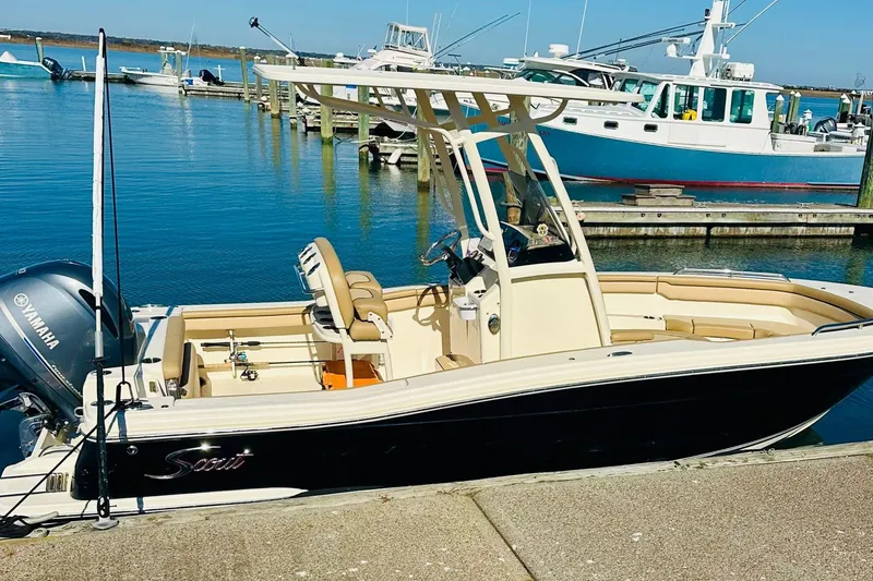 Slide: The Image of 2018 Scout 215 XSF boat docked at marina with Yamaha engine. - 8