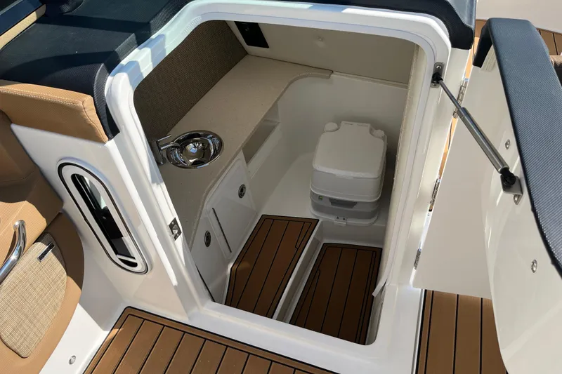 Slide: The Image of 2021 Cobalt R30 boat interior with compact toilet and wooden flooring. - 12