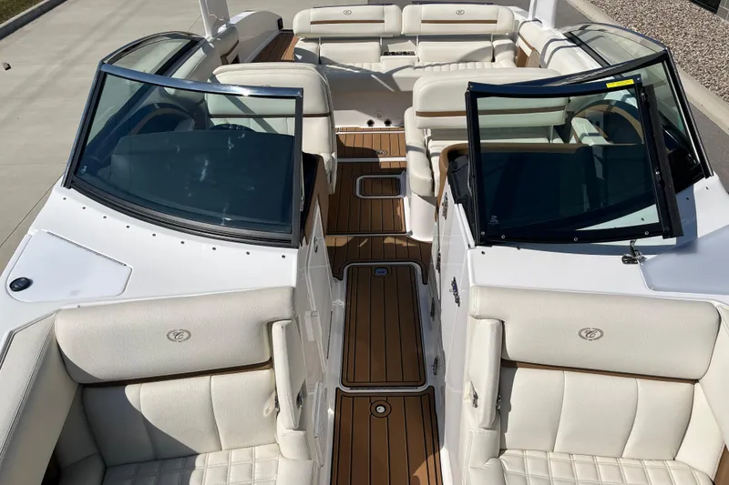 Slide: The Image of 2021 Cobalt R30 boat interior with white leather seats and wooden flooring. - 14