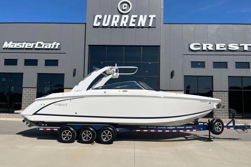 Slide: The Image of 2021 Cobalt R30 boat on trailer outside dealership, featuring sleek design and modern architecture. - 2