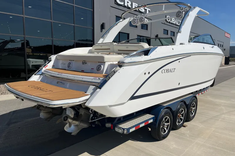 Slide: The Image of 2021 Cobalt R30 boat on trailer, displayed outdoors near a modern building. - 4