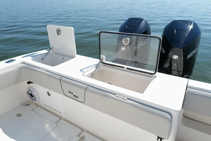 Slide: The Image of 2023 SeaVee 32 boat with dual Mercury engines and open storage compartments. - 13