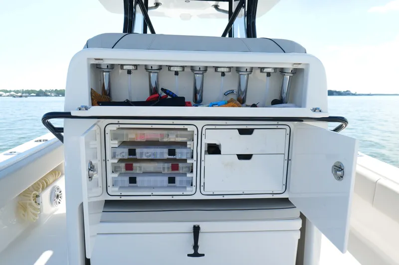 Slide: The Image of 2023 SeaVee 32 boat with open storage compartments and fishing rod holders. - 16