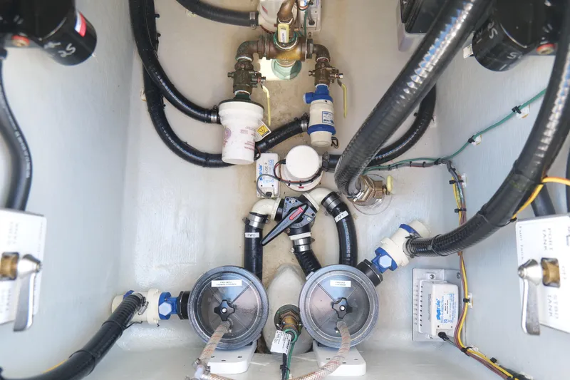 Slide: The Image of Engine compartment of 2023 SeaVee 32 boat, showcasing intricate wiring and plumbing systems. - 18