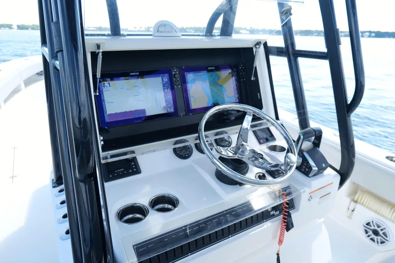 Slide: The Image of 2023 SeaVee 32 boat console with dual navigation screens and steering wheel. - 22