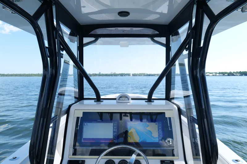 Slide: The Image of 2023 SeaVee 32 boat dashboard with navigation screens on open water. - 27