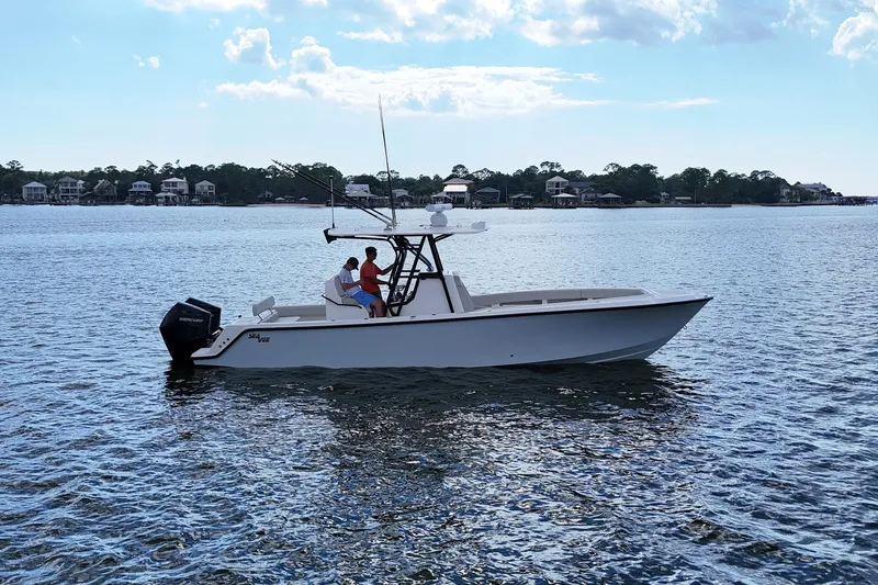 Slide: The Image of 2023 SeaVee 32 boat on calm water with two people onboard. - 3