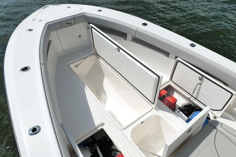 Slide: The Image of 2023 SeaVee 32 boat with open storage compartments on deck. - 40