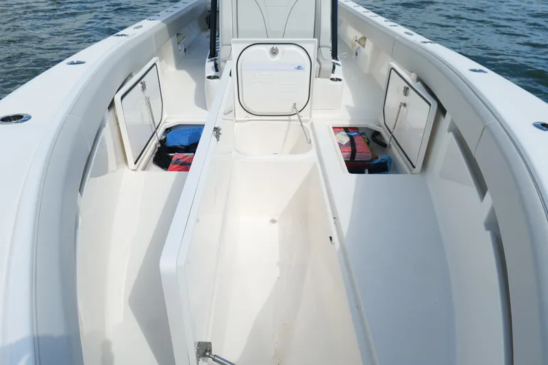Slide: The Image of 2023 SeaVee 32 boat interior with open storage compartments on calm water. - 41