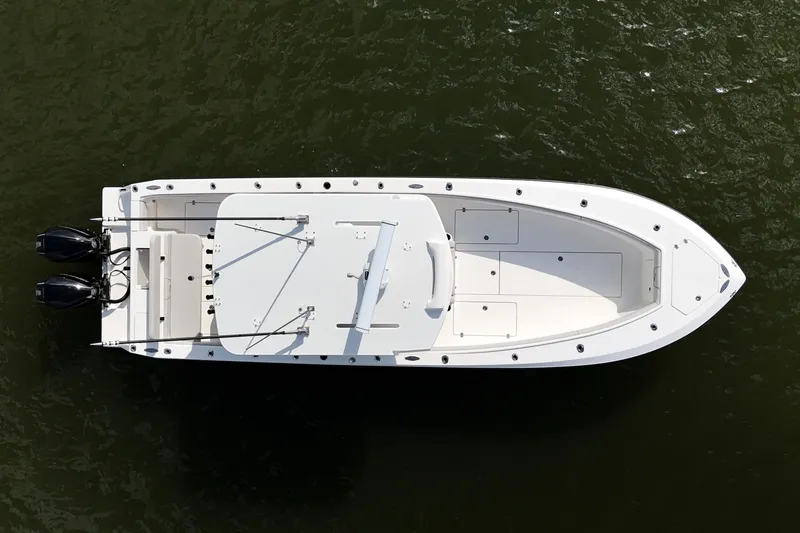 Slide: The Image of 2023 SeaVee 32 boat, aerial view, on water, showcasing sleek design and dual engines. - 45
