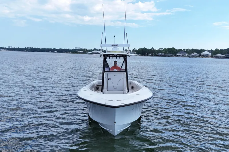 Slide: The Image of 2023 SeaVee 32 boat on calm water under a partly cloudy sky. - 5