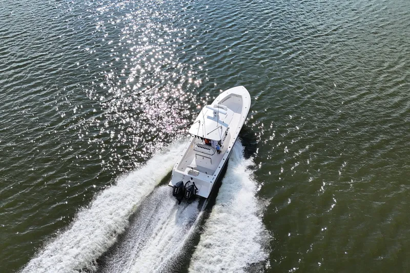 Slide: The Image of 2023 SeaVee 32 boat cruising on sparkling water, aerial view. - 54