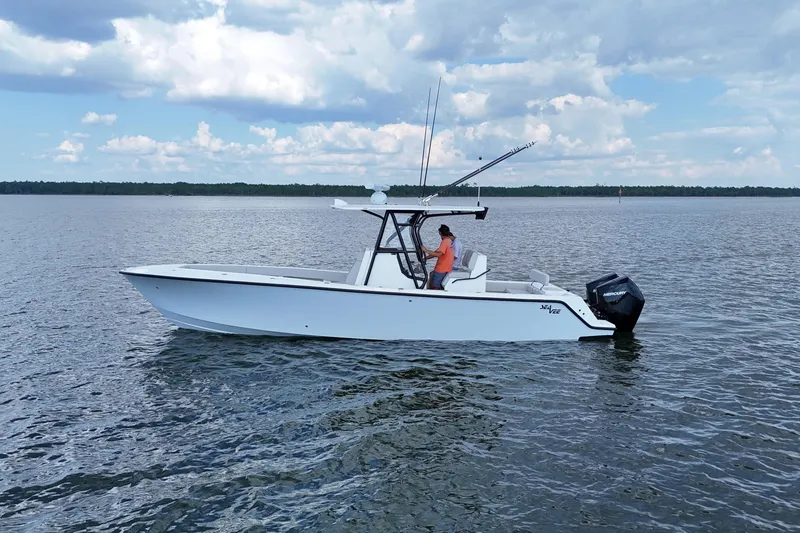 Slide: The Image of 2023 SeaVee 32 boat on calm water under a partly cloudy sky. - 8
