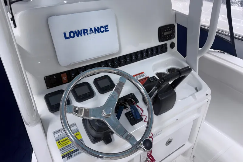 Slide: The Image of 2015 Sea Hunt Gamefish 25 boat console with steering wheel and Lowrance electronics. - 13