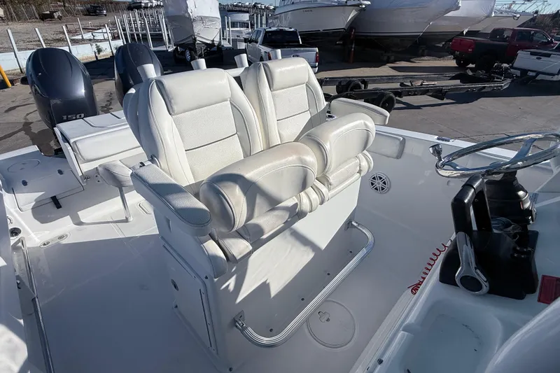 Slide: The Image of 2015 Sea Hunt Gamefish 25 boat interior with dual seats and steering console. - 14