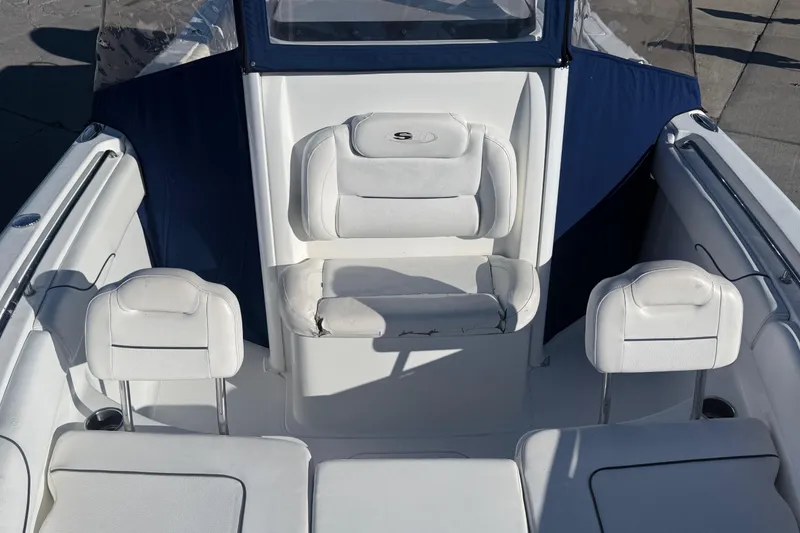 Slide: The Image of 2015 Sea Hunt Gamefish 25 boat interior with white seating and blue accents. - 15