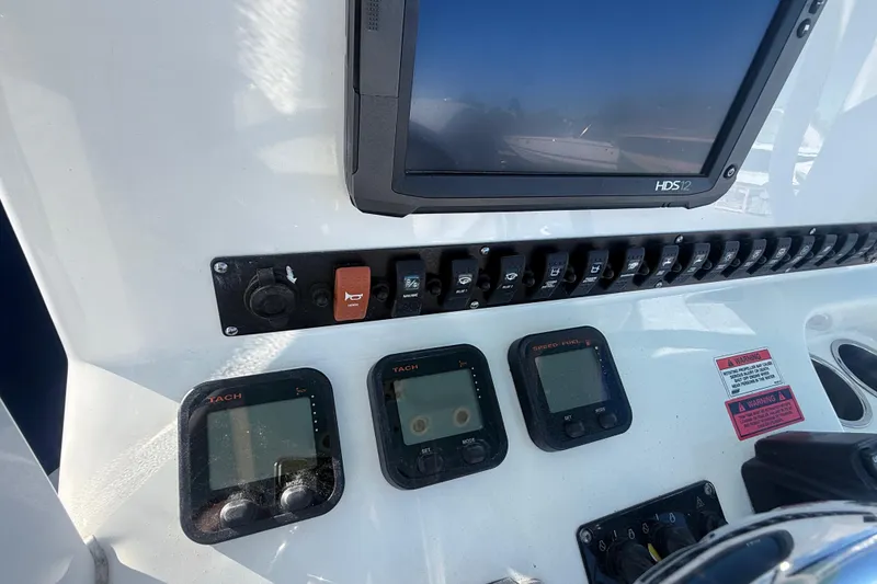 Slide: The Image of Control panel of a 2015 Sea Hunt Gamefish 25 boat with electronic displays and switches. - 20