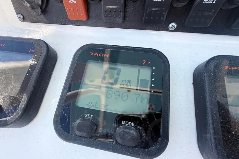 Slide: The Image of Close-up of a 2015 Sea Hunt Gamefish 25 tachometer display on a boat dashboard. - 21