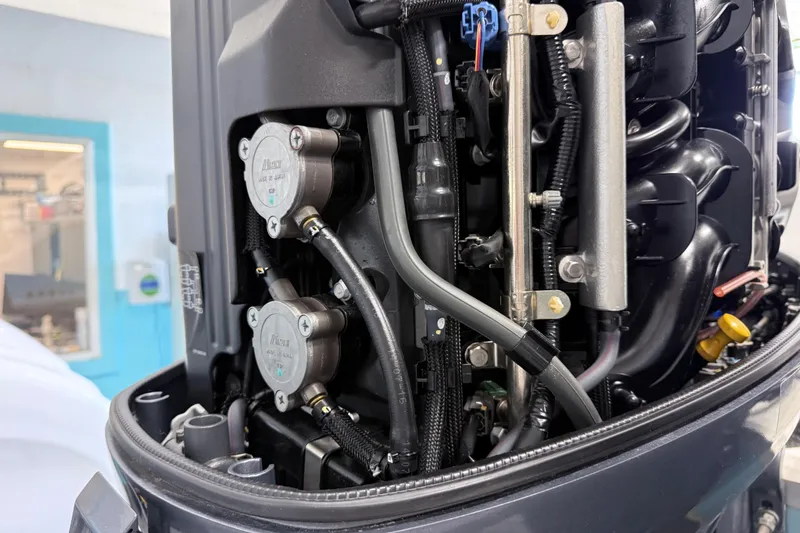 Slide: The Image of Close-up of a 2015 Sea Hunt Gamefish 25 engine components and wiring. - 26