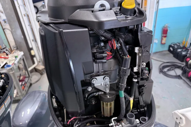 Slide: The Image of 2015 Sea Hunt Gamefish 25 engine close-up in a workshop setting. - 27