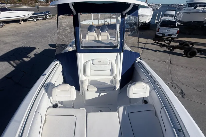 Slide: The Image of 2015 Sea Hunt Gamefish 25 boat interior with seating, docked at marina. - 29