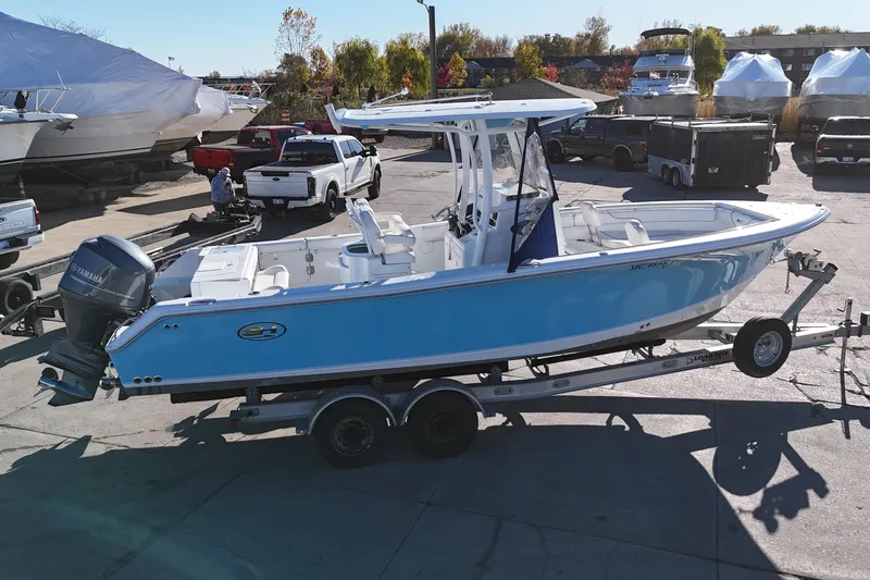 Slide: The Image of 2015 Sea Hunt Gamefish 25 boat on trailer in marina setting. - 3
