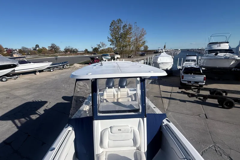 Slide: The Image of 2015 Sea Hunt Gamefish 25 boat docked at marina with clear blue sky. - 30