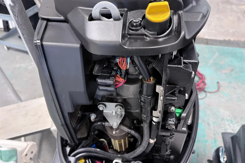 Slide: The Image of Close-up of a 2015 Sea Hunt Gamefish 25 engine compartment with visible wiring and components. - 31