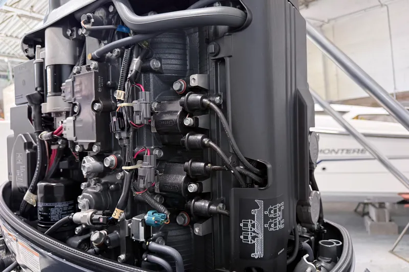 Slide: The Image of Close-up of a 2015 Sea Hunt Gamefish 25 outboard motor in a workshop. - 33