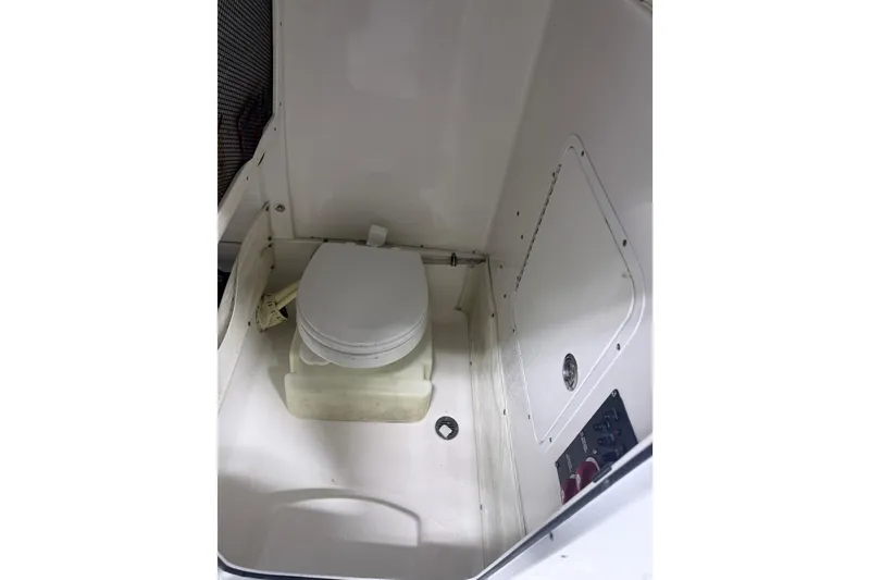 Slide: The Image of 2015 Sea Hunt Gamefish 25 boat interior with compact marine toilet. - 34