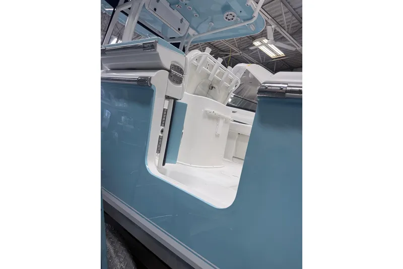 Slide: The Image of 2015 Sea Hunt Gamefish 25 boat interior with blue exterior and white seating. - 35