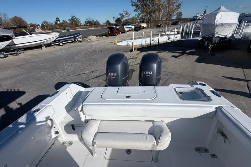 Slide: The Image of 2015 Sea Hunt Gamefish 25 boat with dual 150 horsepower engines at a marina. - 9