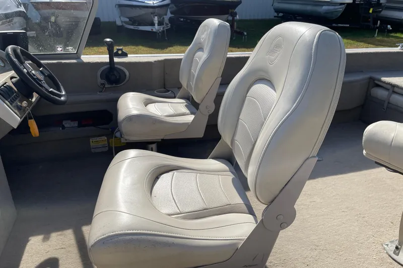 Slide: The Image of 2004 Starcraft C-Star 1800 OB boat seat with a Mercury engine in the background. - 11