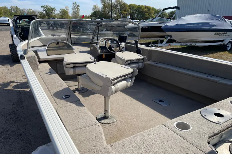 Slide: The Image of 2004 Starcraft C-Star 1800 OB boat deck, parked among other boats. - 6