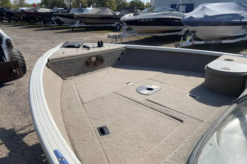 Slide: The Image of 2004 Starcraft C-Star 1800 OB boat interior with carpeted deck and windshield. - 7