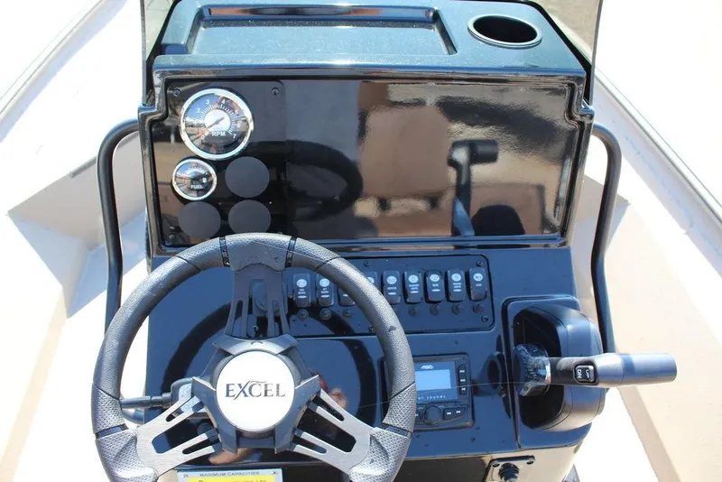 Slide: The Image of 2026 Excel Bay Pro Elite 230 boat dashboard with steering wheel and control panel. - 11