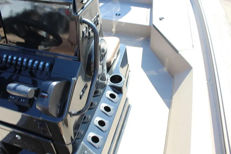 Slide: The Image of Control panel of 2026 Excel Bay Pro Elite 230 boat with cup holders. - 16