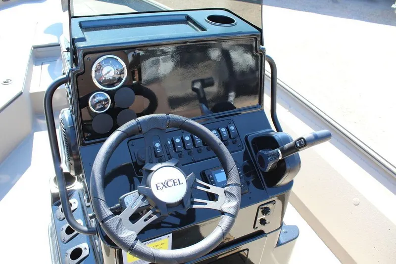 Slide: The Image of 2026 Excel Bay Pro Elite 230 boat dashboard with steering wheel and controls. - 18