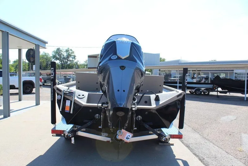 Slide: The Image of 2026 Excel Bay Pro Elite 230 boat on trailer, rear view in a dealership lot. - 9