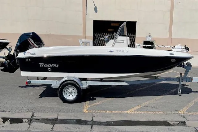 The Image of 2026 Bayliner Trophy T18 boat on trailer, parked outdoors. - 0