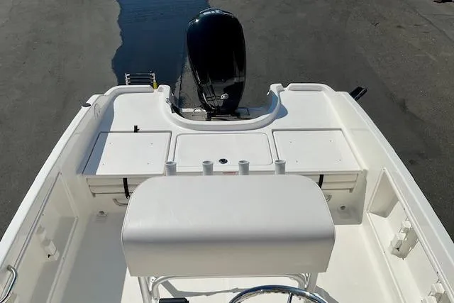 Slide: The Image of 2026 Bayliner Trophy T18 boat interior with seating and motor, viewed from above. - 12