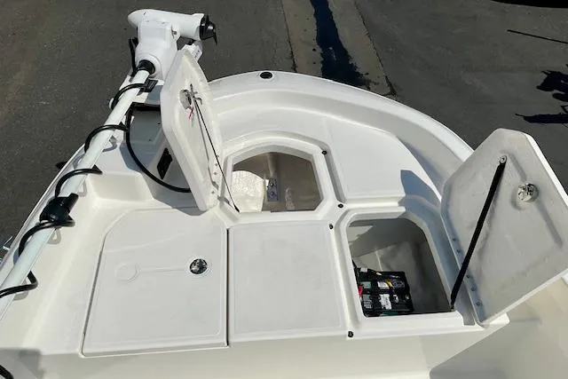 Slide: The Image of 2026 Bayliner Trophy T18 boat deck with open storage compartments and trolling motor. - 14