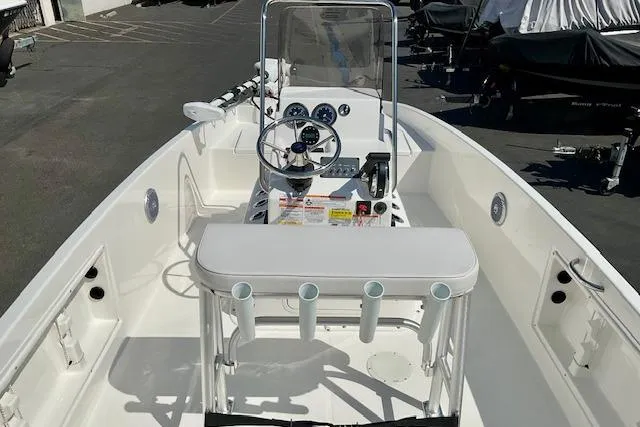 Slide: The Image of 2026 Bayliner Trophy T18 boat interior with steering console and rod holders. - 18